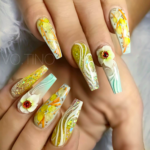 Yellow flower acrylic nail art with dried flowers